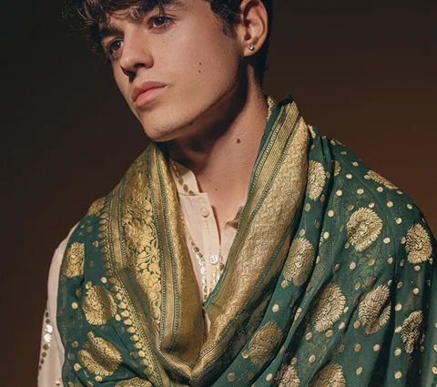 Person wearing a textured green and gold shawl