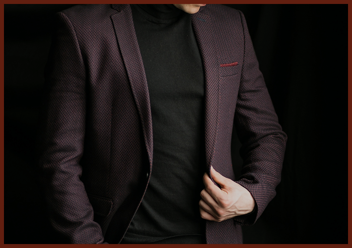 Person in a purple blazer and black turtleneck.