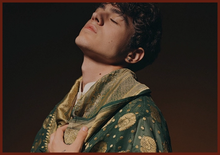 Person wearing a textured green and gold shawl